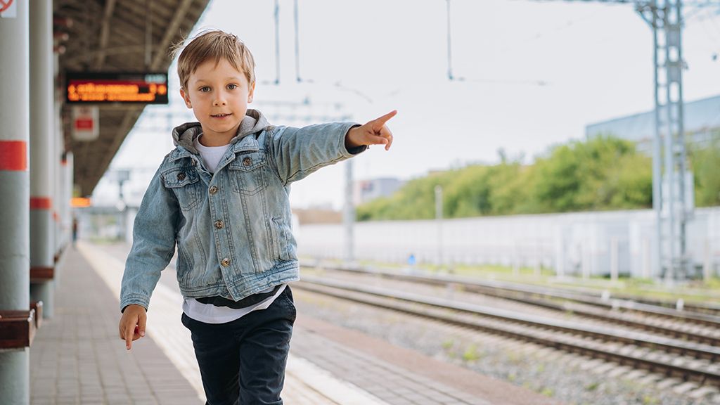 Dziecko wskazujące drogę na peronie - zniżki dla dzieci w PKP